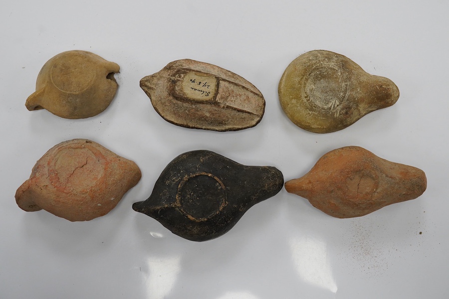 Six late Roman pottery lamps, three decorated with figures, including one with Christ in Majesty, and one decorated with the Chi Rho. Condition - fair to good.